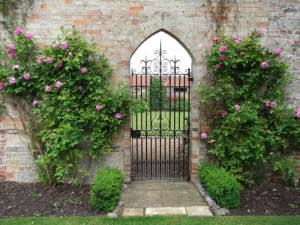 The gateway to the walled garden with fragrant roses surrounding it